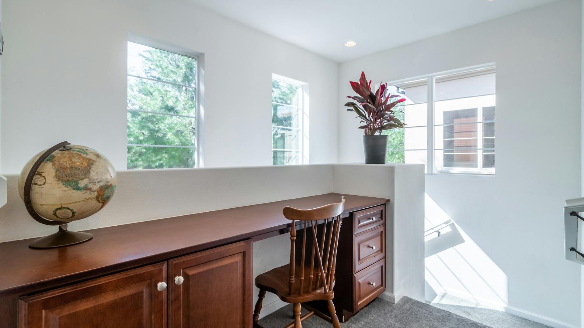 Bright and airy home office with natural wood desk.