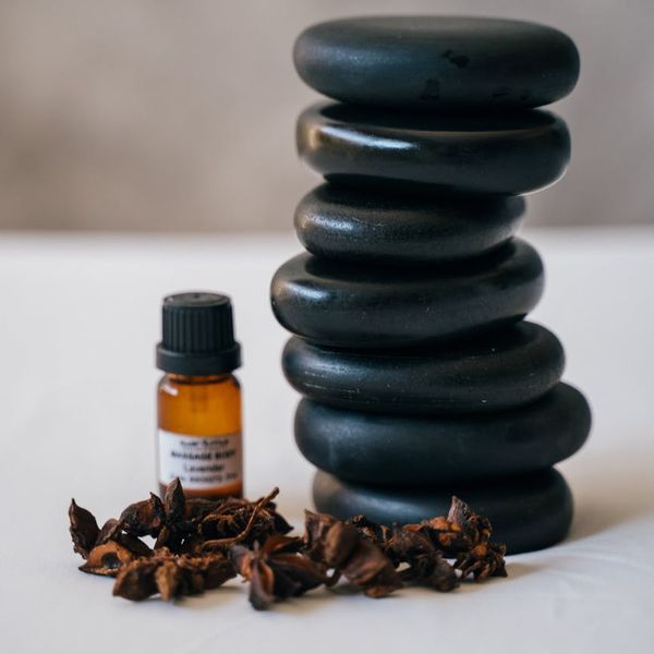 Close up of essential oils and smooth stones.